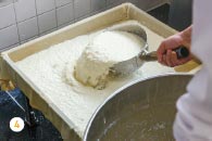 4 Transferring the thickened soymilk into the mold before the nigari solidifies it